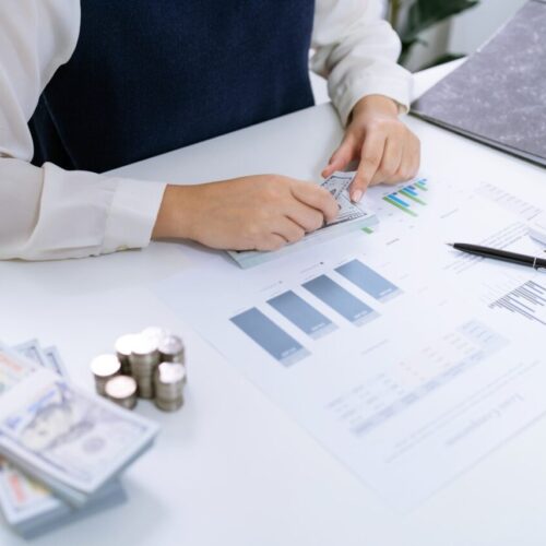 businesswoman-accountant-analyzing-investment-charts-invoice-and-pressing.jpg